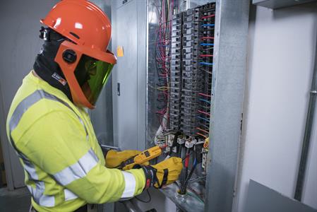 Electrical Worker Wearing Rubber Insulating Gloves and Leather Protectors